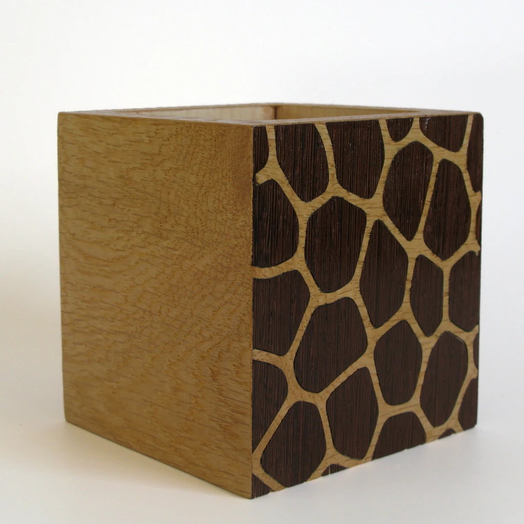 FOCUS Stiftehalter, Wenge und Eiche: helle Eichenflaeche links, rechts die Seitenflaeche mit dunklem Wenge-Muster in hellen Zellkanten